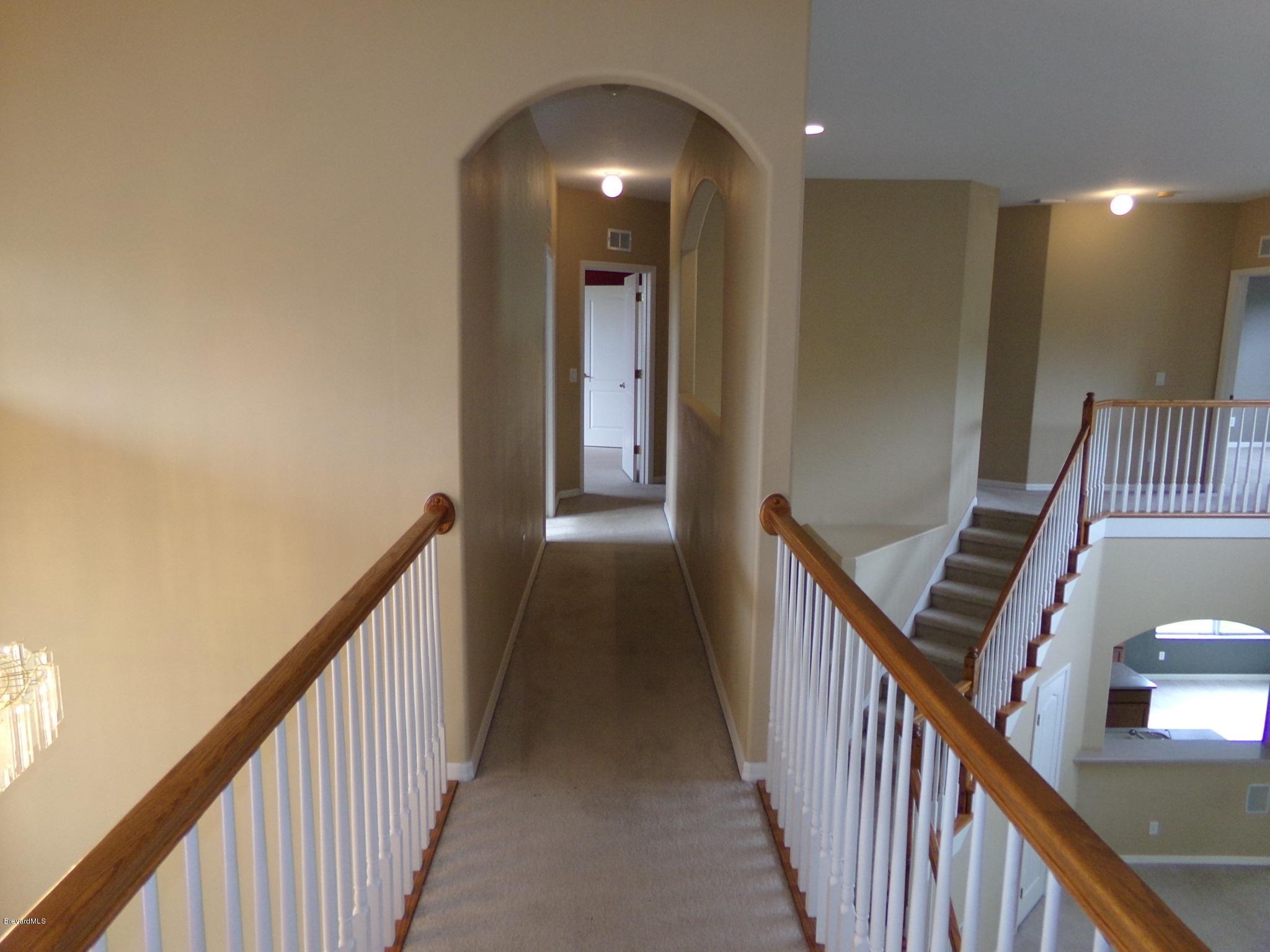 3995 Harlock Road Melbourne, FL 32934 - Photo 23 of 34 a view of a hallway view with staircase