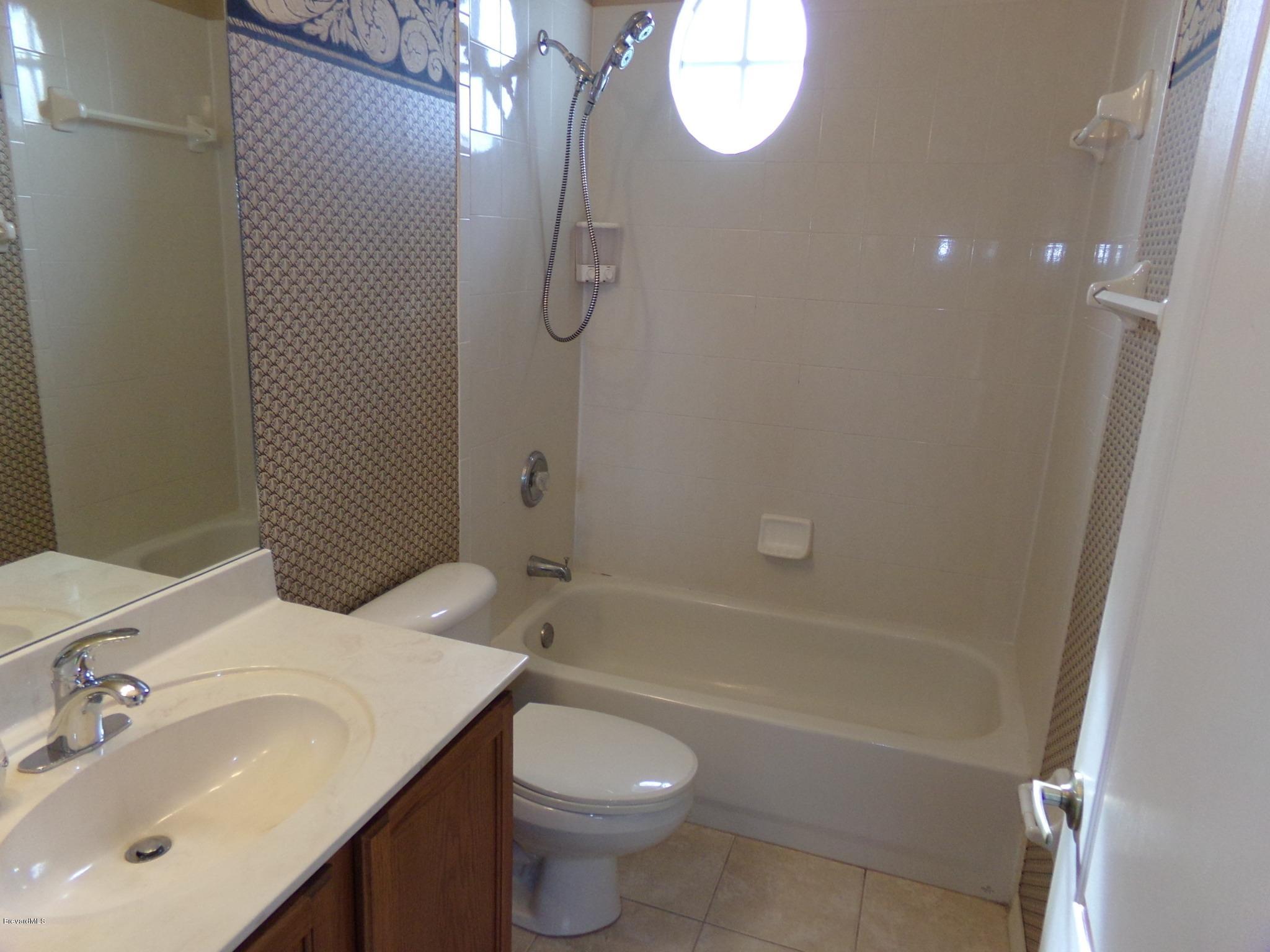 3995 Harlock Road Melbourne, FL 32934 - Photo 28 of 34 a bathroom with a sink a toilet and shower
