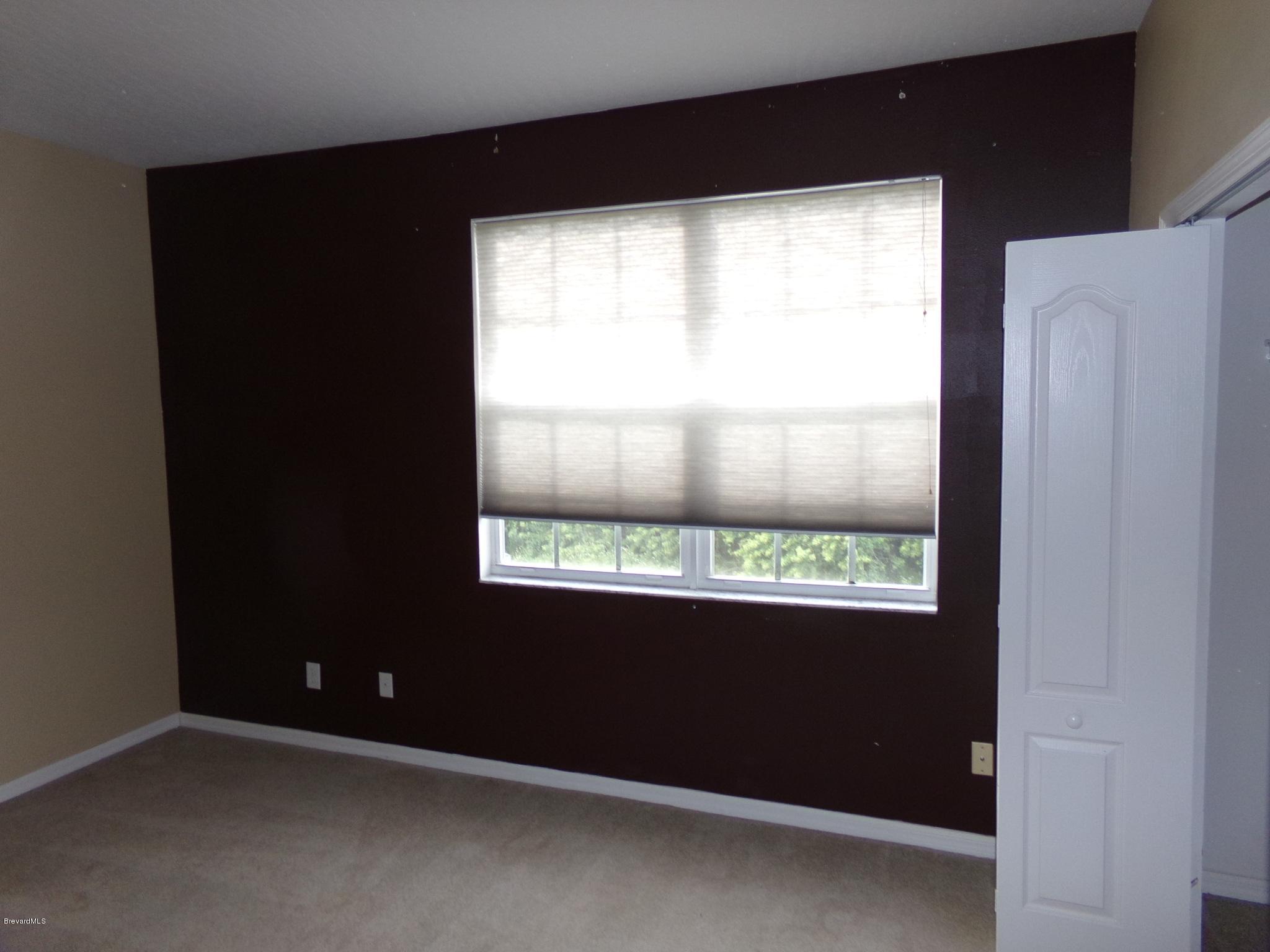 3995 Harlock Road Melbourne, FL 32934 - Photo 29 of 34 a view of an empty room with a window