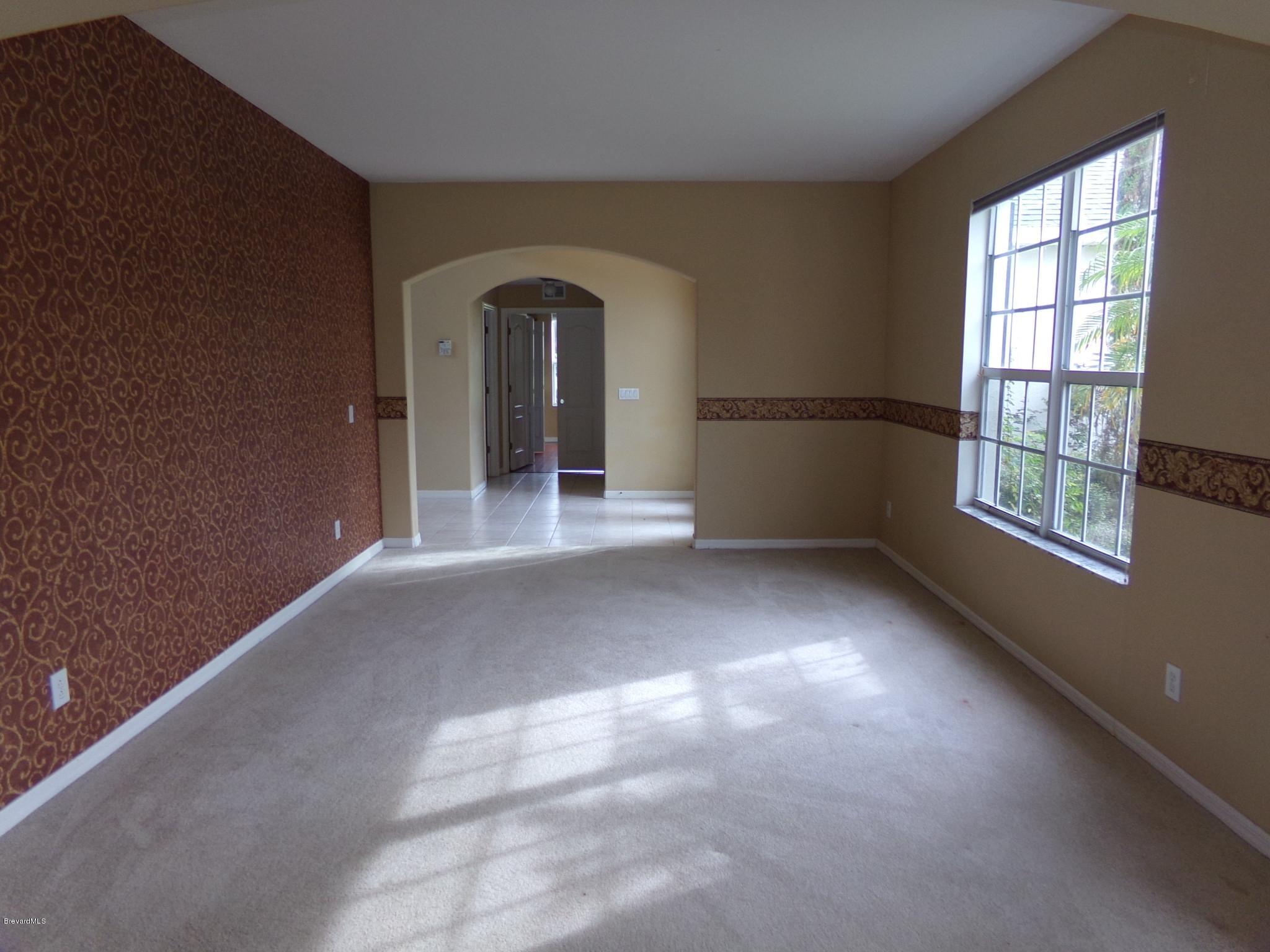 3995 Harlock Road Melbourne, FL 32934 - Photo 4 of 34 an empty room with windows