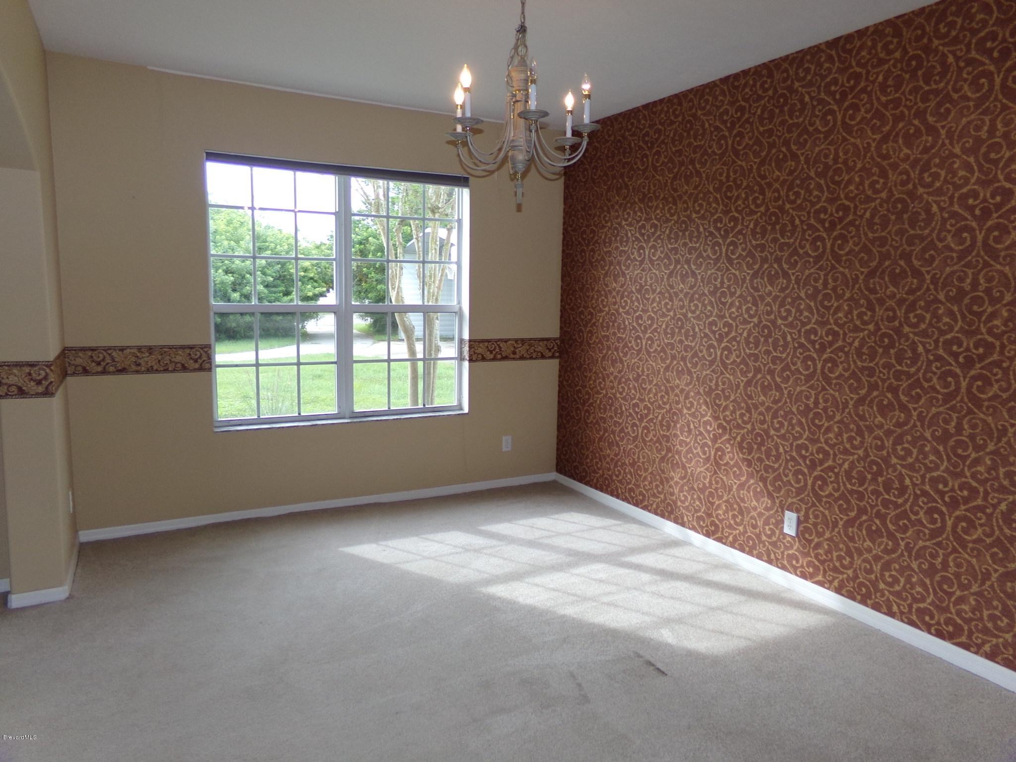 3995 Harlock Road Melbourne, FL 32934 - Photo 5 of 34 a view of an empty room with a window