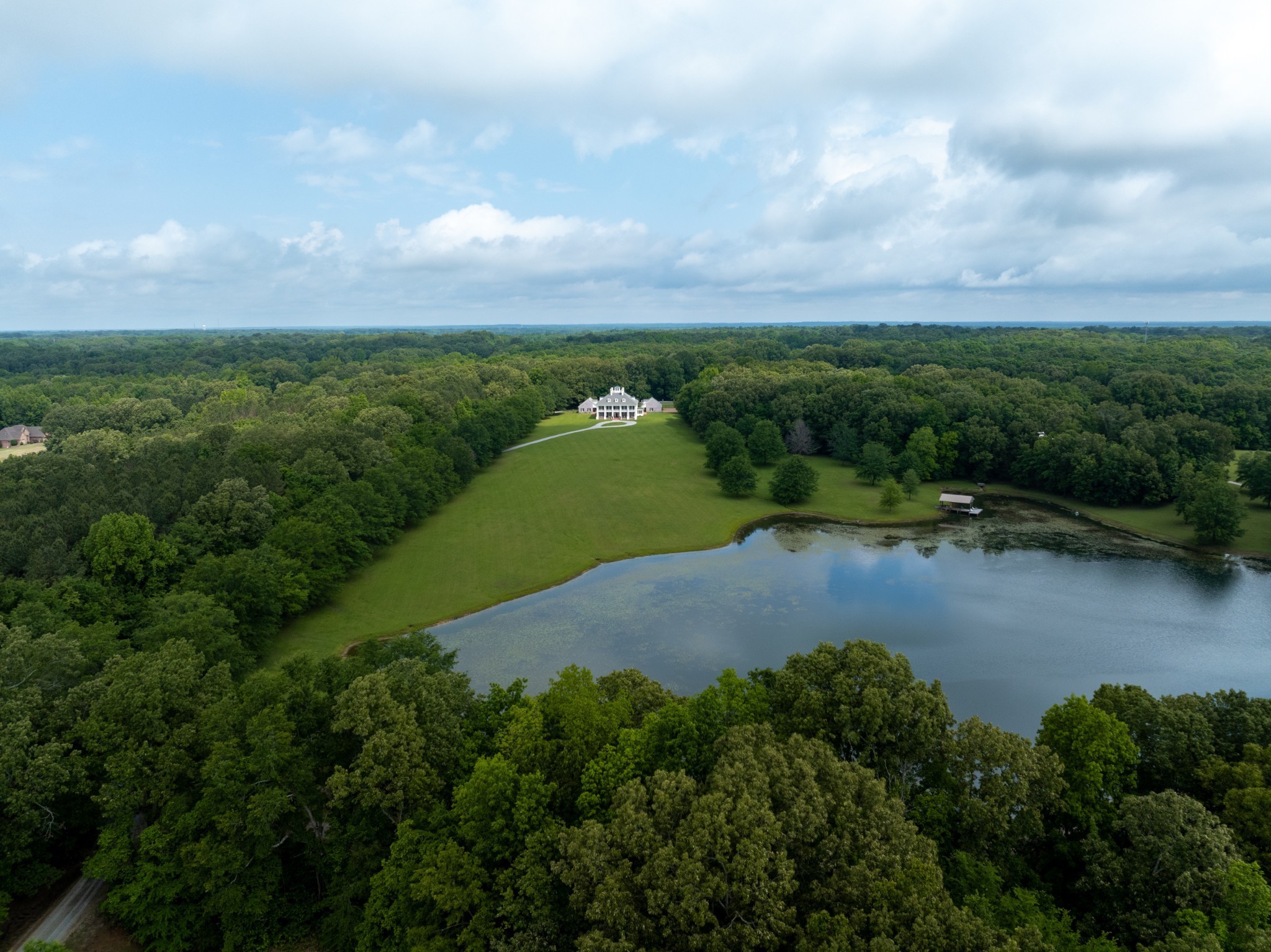 an aerial view of a houses with outdoor space and lake view