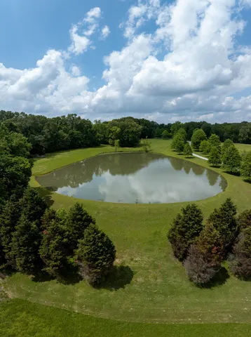 a front view of a building with a yard