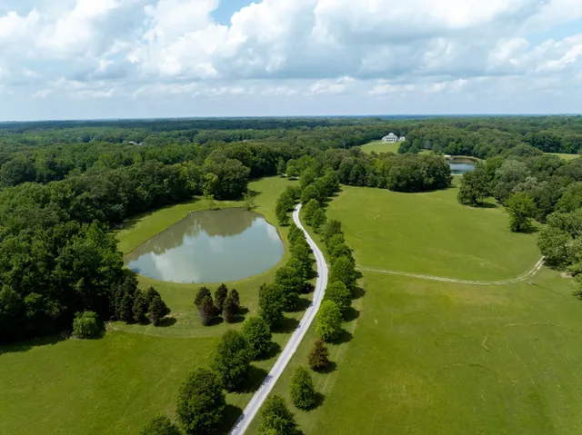 a living room with furniture chandelier and a table