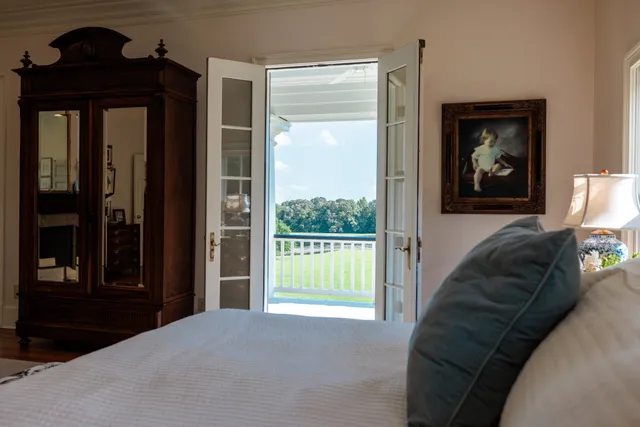 an aerial view of residential house with outdoor space and trees all around