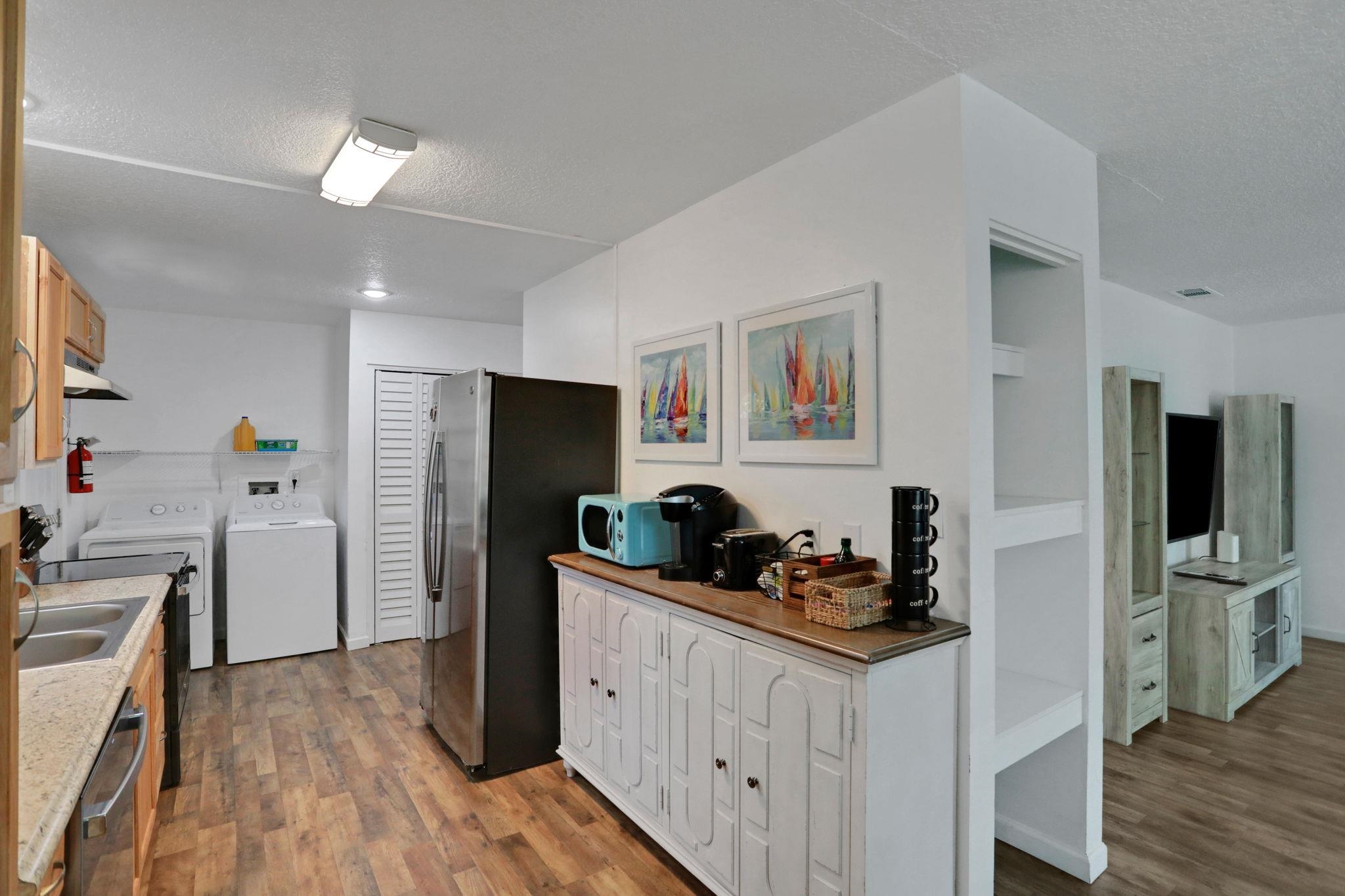 237 Riberia Street St. Augustine, FL 32084 - Photo 11 of 36 a kitchen with stainless steel appliances kitchen island granite countertop a refrigerator and a stove top oven