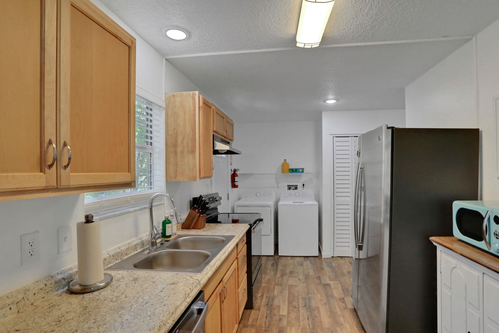 237 Riberia Street St. Augustine, FL 32084 - Photo 12 of 36 a kitchen with a sink a refrigerator and cabinets