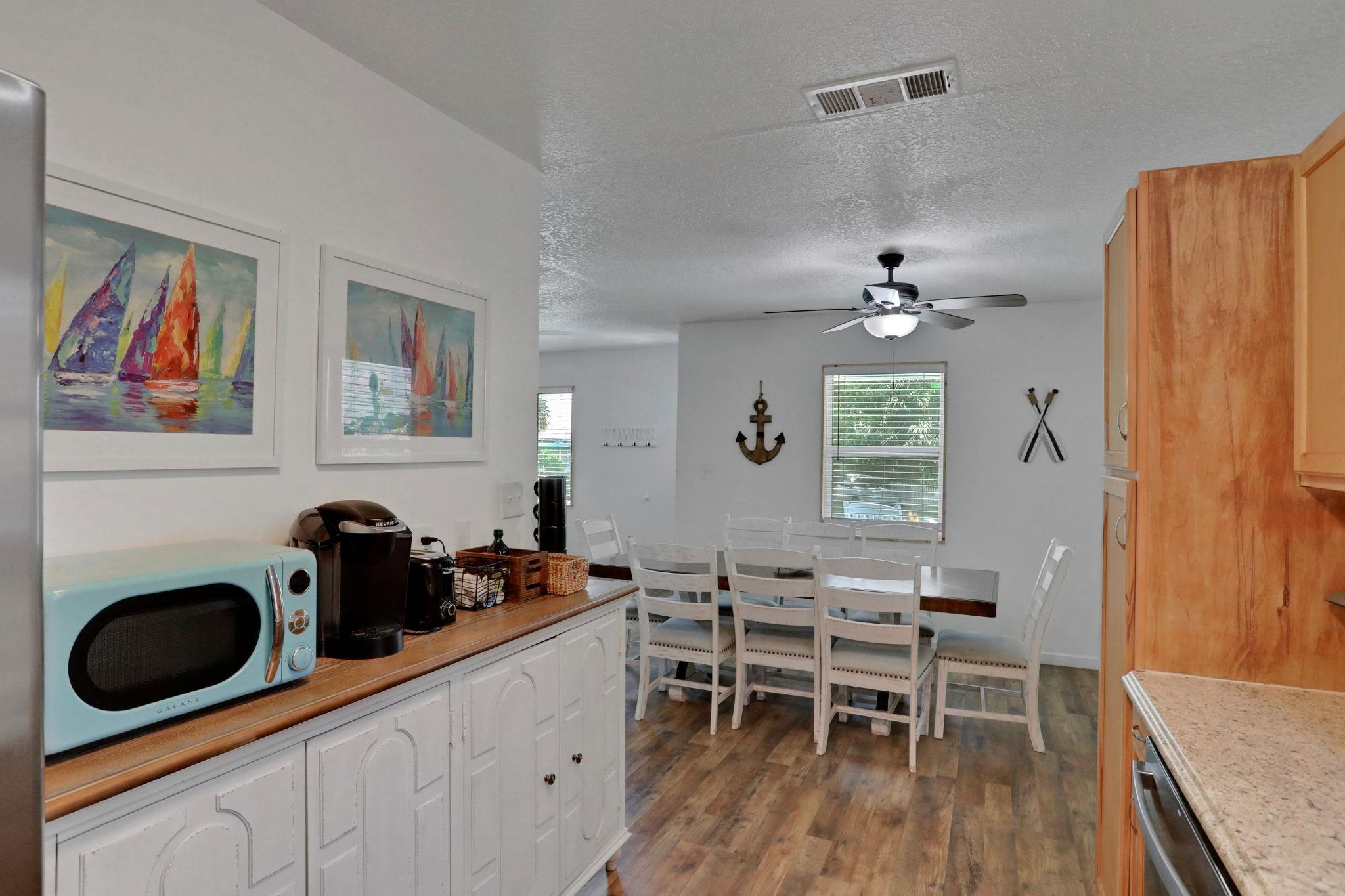 237 Riberia Street St. Augustine, FL 32084 - Photo 15 of 36 a kitchen with stainless steel appliances granite countertop a stove a sink a dining table and chairs with wooden floor