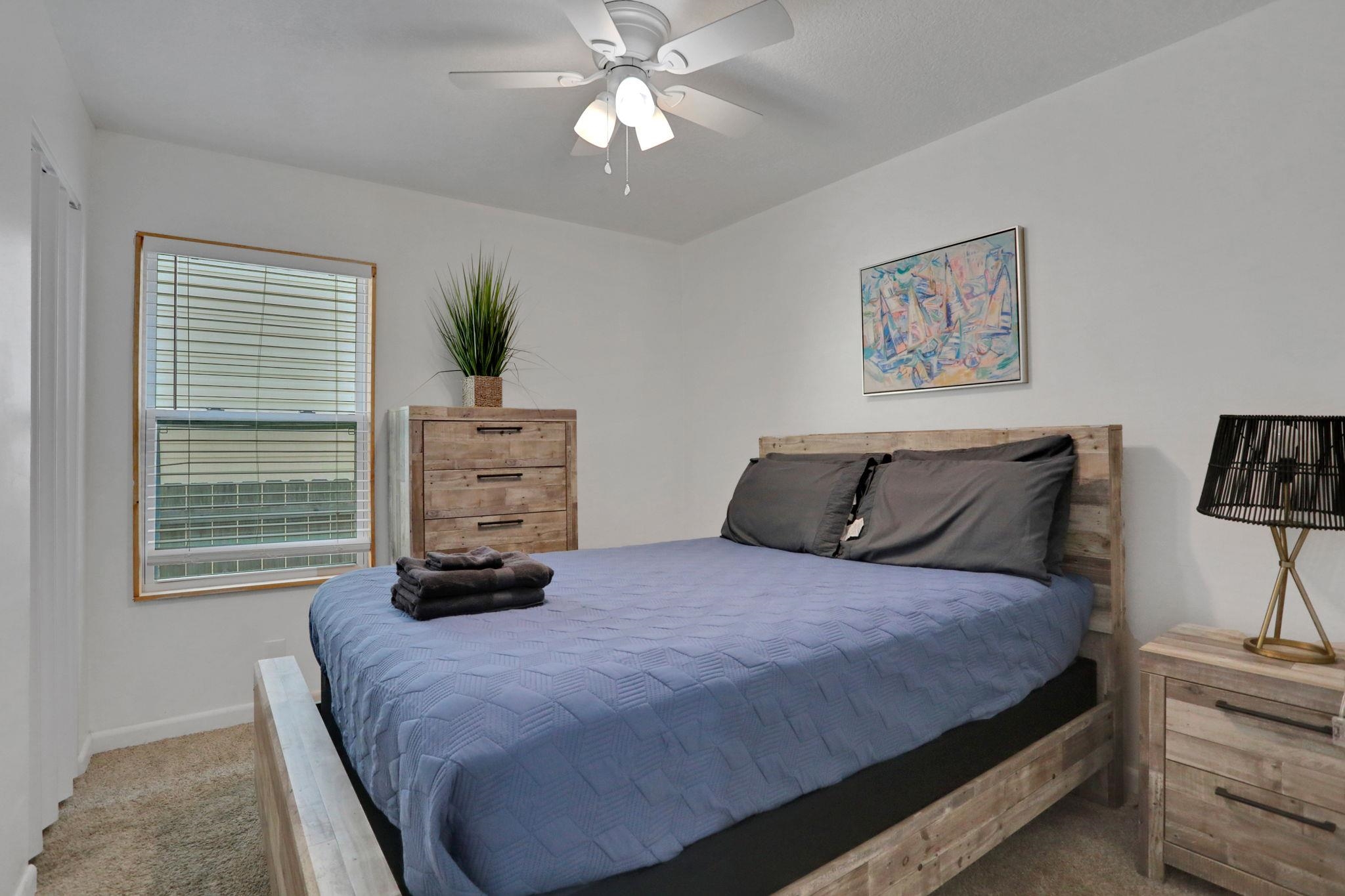 237 Riberia Street St. Augustine, FL 32084 - Photo 17 of 36 a bedroom with a bed a window and a chandelier