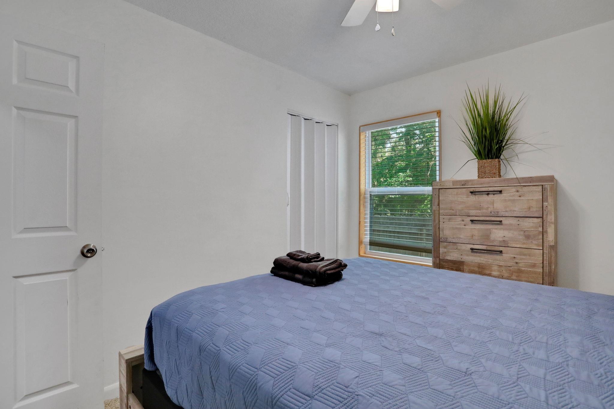 237 Riberia Street St. Augustine, FL 32084 - Photo 18 of 36 a bedroom with a bed and a potted plant