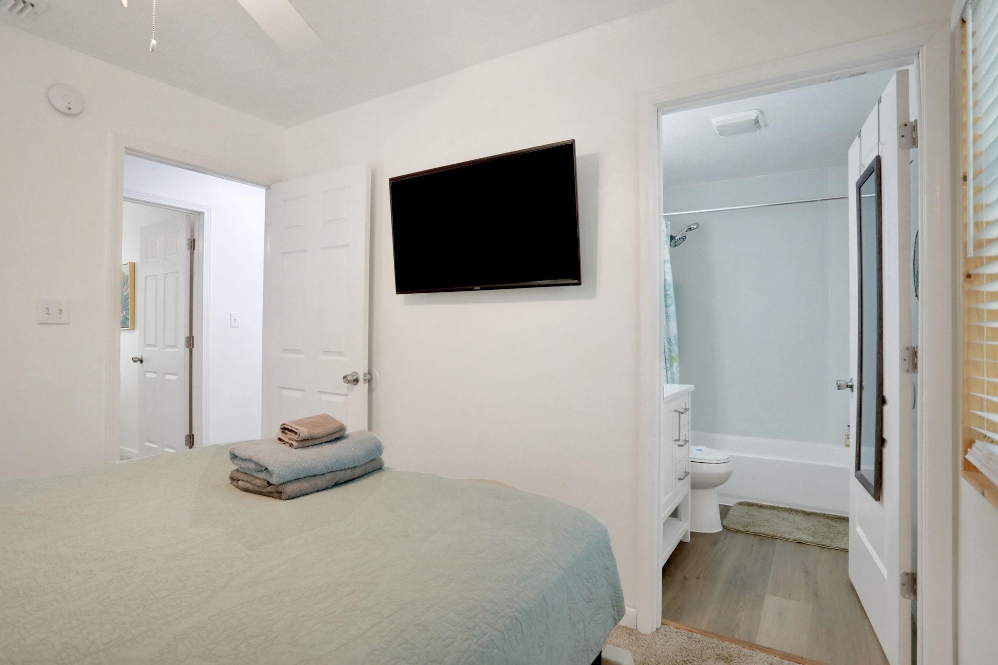237 Riberia Street St. Augustine, FL 32084 - Photo 26 of 36 a bedroom with a bed and a flat screen tv