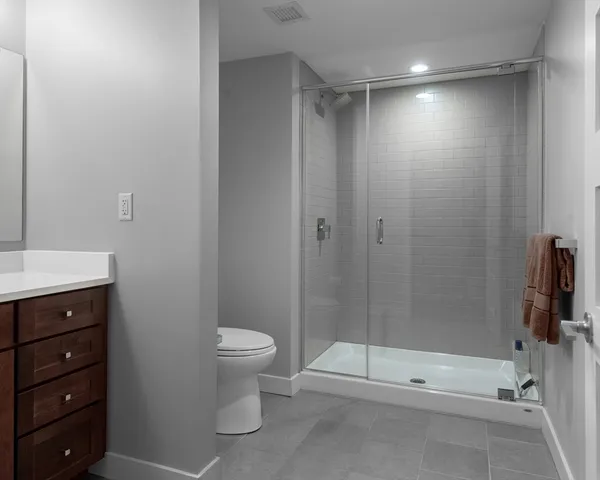 a bathroom with a shower a toilet and a sink