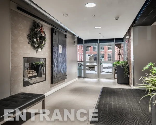 a lobby with furniture and potted plant