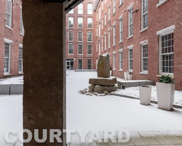 a front view of a building with outdoor seating
