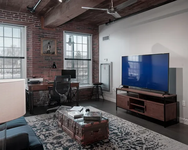 a living room with furniture and a piano