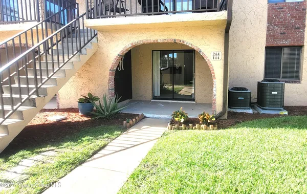 a view of a living room with a fireplace and a large window