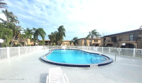 a swimming pool with outdoor seating and yard