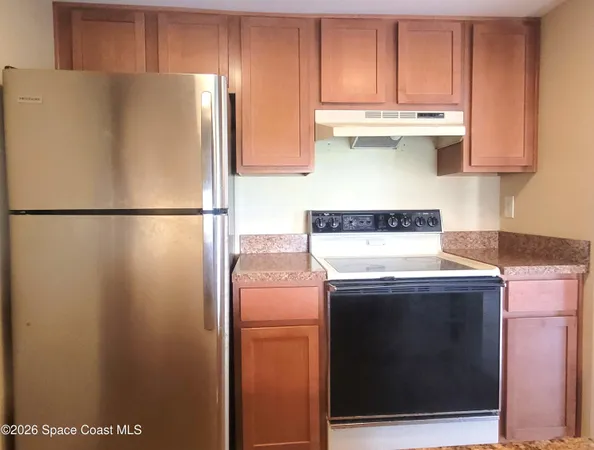 a white refrigerator freezer sitting inside of a kitchen