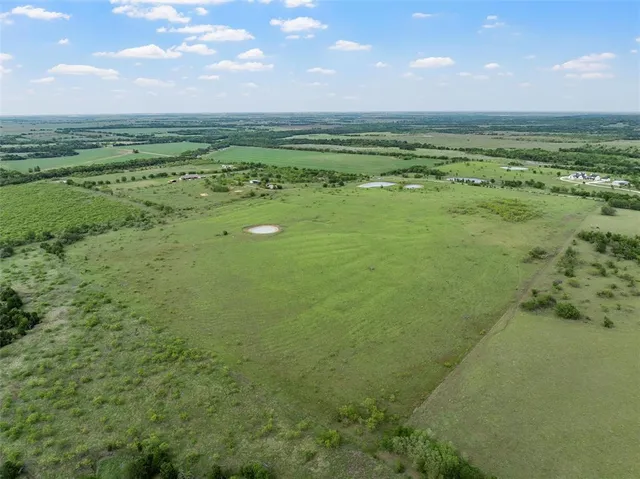 a view of a field with an ocean view