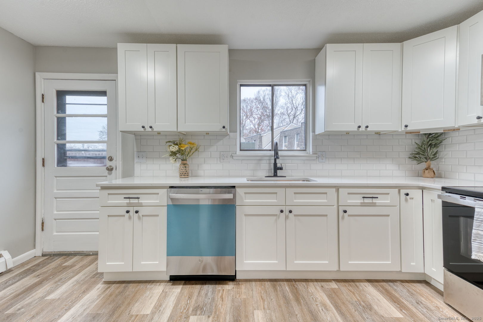 142 High Path Road, Unit 142 Windsor, CT 06095 - Photo 11 of 35 a kitchen with white cabinets and sink