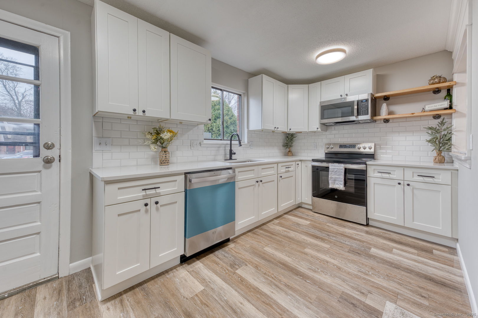 142 High Path Road, Unit 142 Windsor, CT 06095 - Photo 12 of 35 a kitchen with white cabinets stainless steel appliances and sink