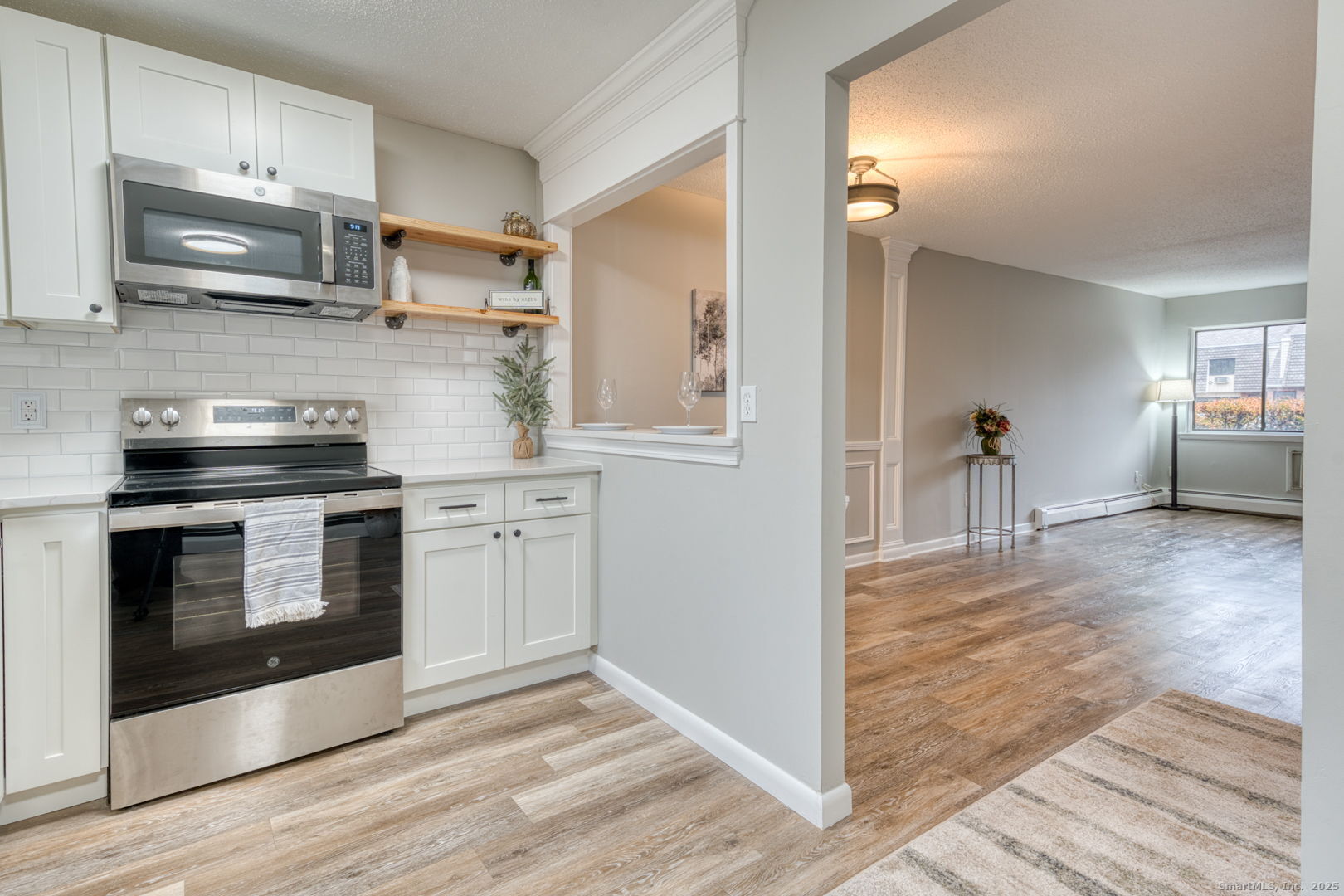 142 High Path Road, Unit 142 Windsor, CT 06095 - Photo 17 of 35 a kitchen with stainless steel appliances a stove a microwave and cabinets