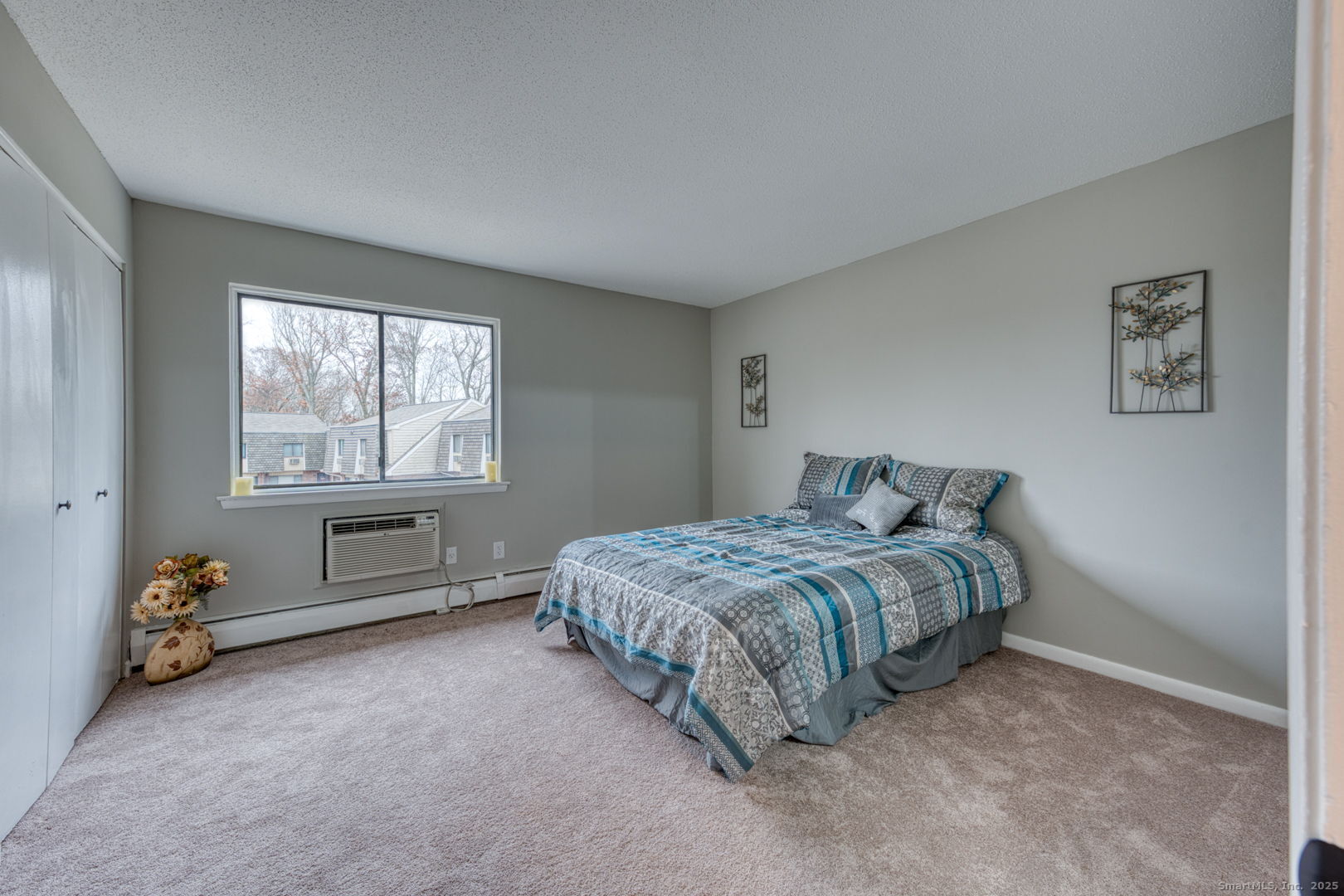 142 High Path Road, Unit 142 Windsor, CT 06095 - Photo 18 of 35 a bed sitting in a bedroom next to a window