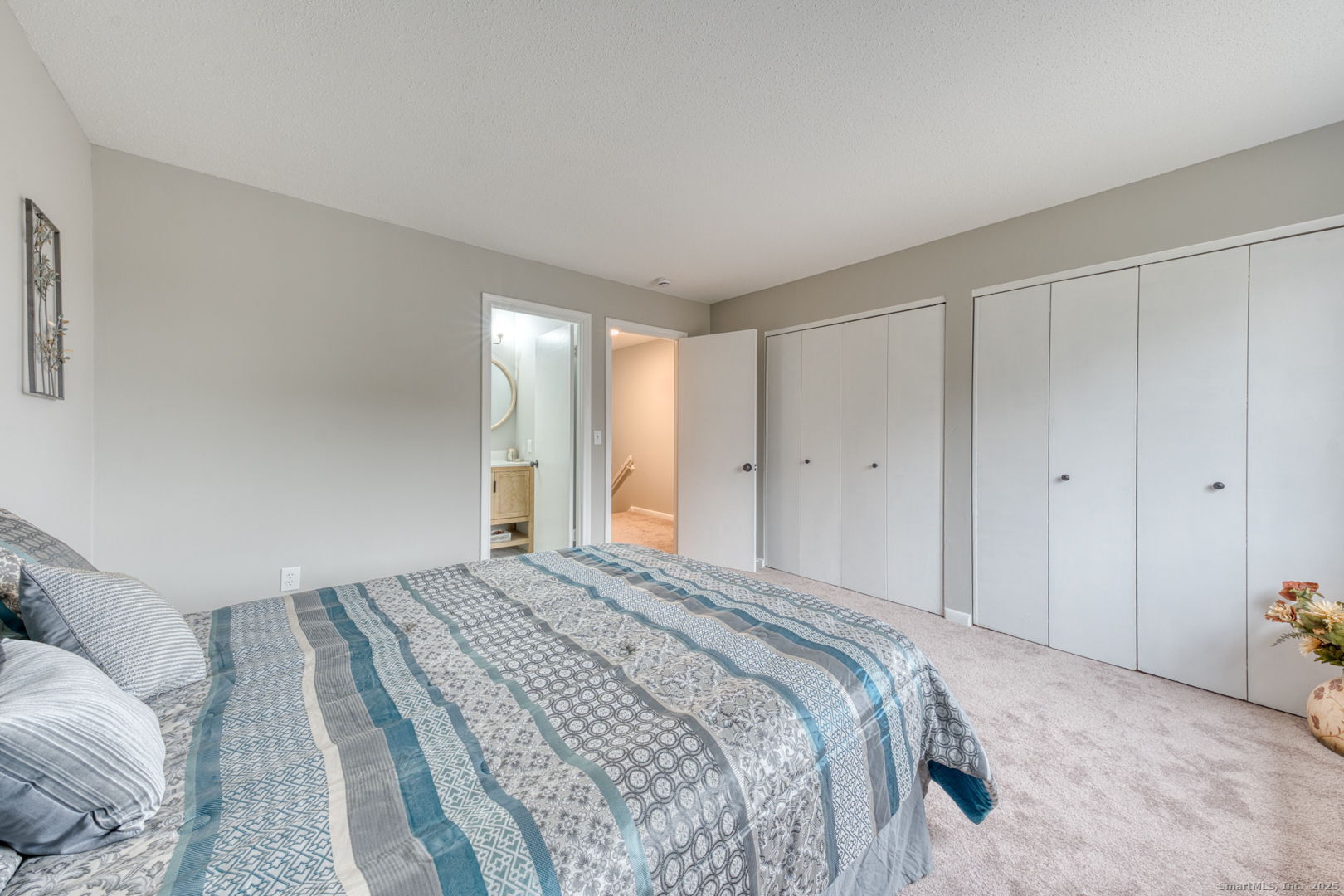 142 High Path Road, Unit 142 Windsor, CT 06095 - Photo 20 of 35 a bedroom with a bed and a painting on the wall