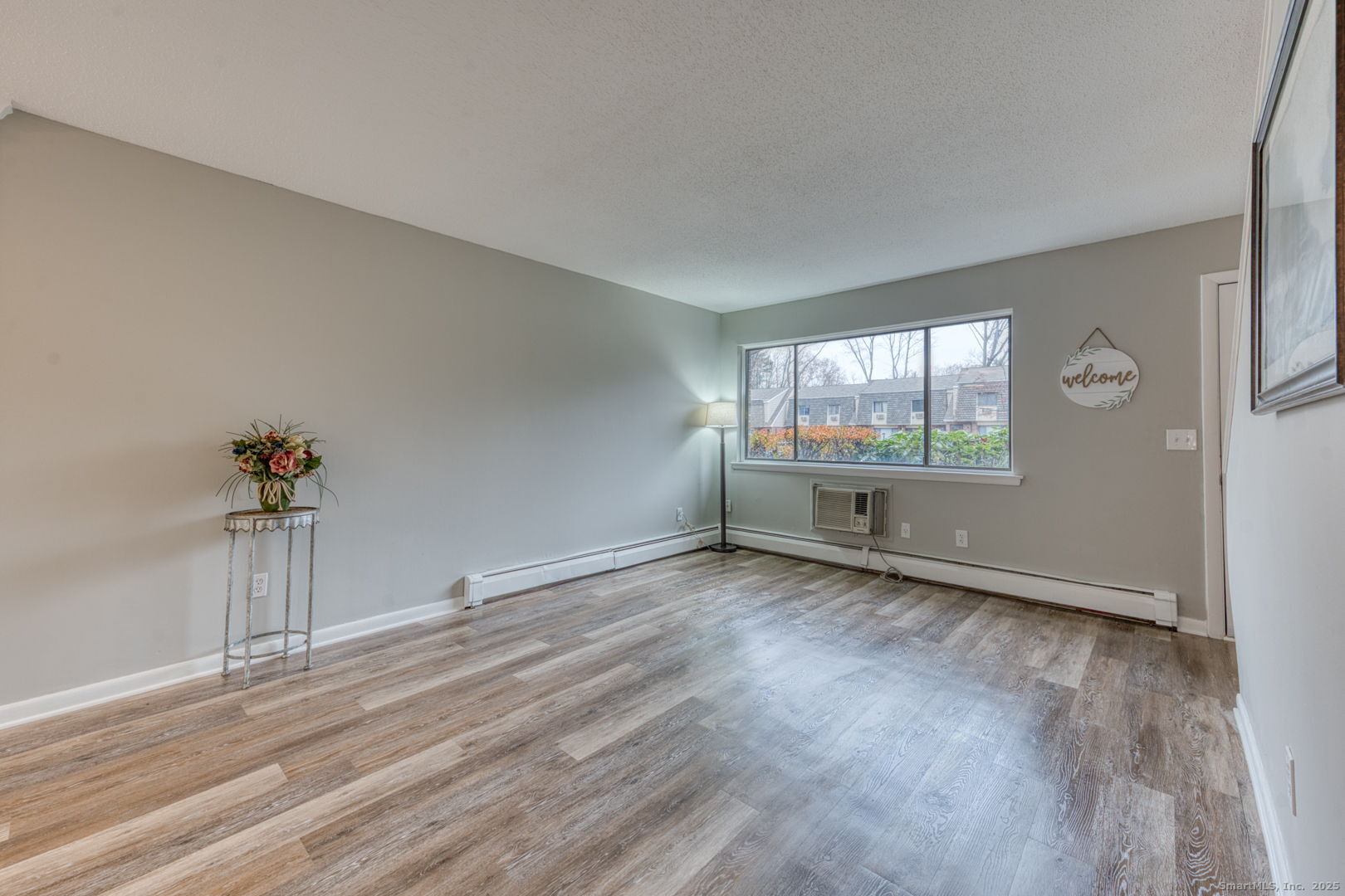 142 High Path Road, Unit 142 Windsor, CT 06095 - Photo 4 of 35 a view of empty room with wooden floor and fan