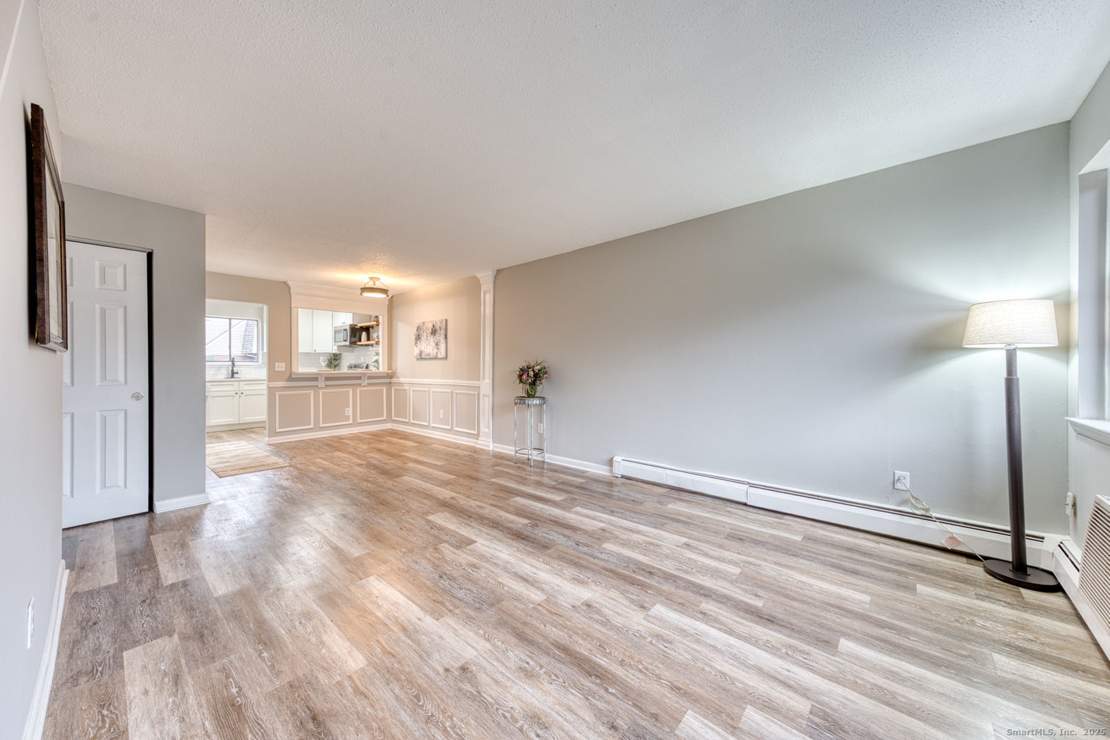 142 High Path Road, Unit 142 Windsor, CT 06095 - Photo 5 of 35 a view of a kitchen with wooden floor and a refrigerator
