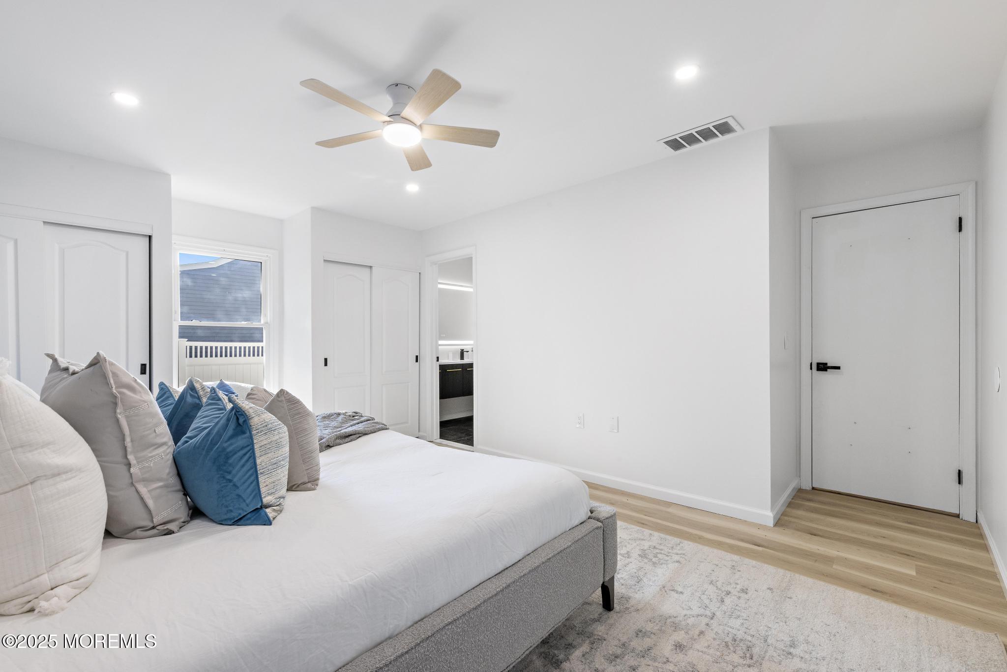 247 Jennings Road Manahawkin, NJ 08050 - Photo 11 of 16 a bedroom with a large bed and ceiling fan
