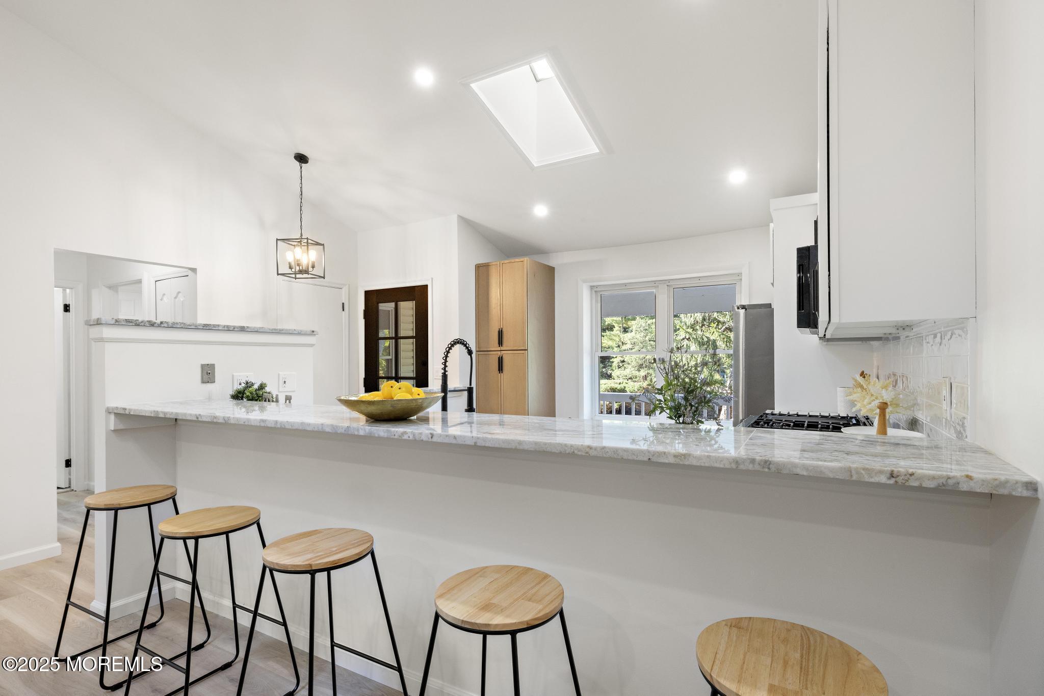 247 Jennings Road Manahawkin, NJ 08050 - Photo 12 of 35 a kitchen with stainless steel appliances granite countertop a sink and a refrigerator