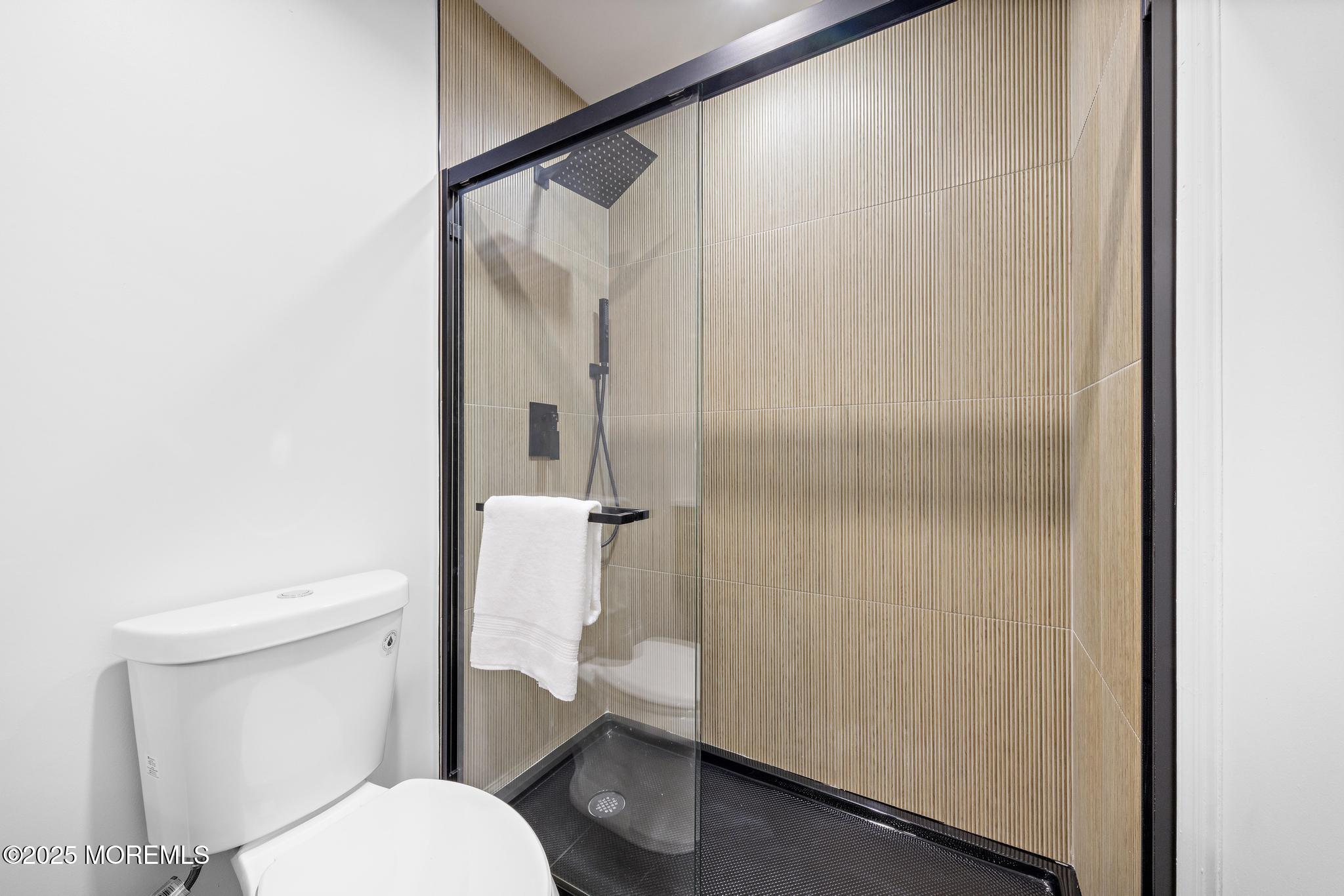247 Jennings Road Manahawkin, NJ 08050 - Photo 12 of 16 a white toilet sitting next to a bathroom sink