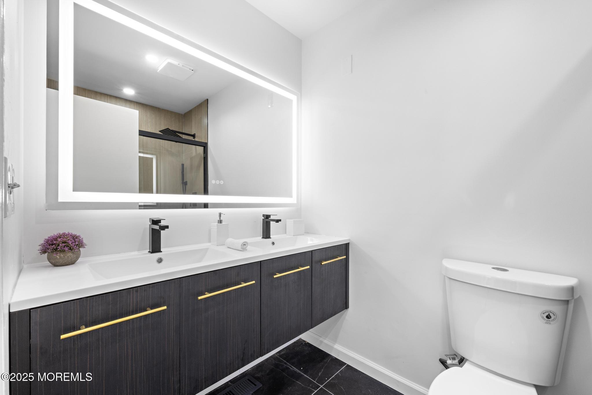 247 Jennings Road Manahawkin, NJ 08050 - Photo 13 of 16 a bathroom with a toilet sink double vanity and mirror