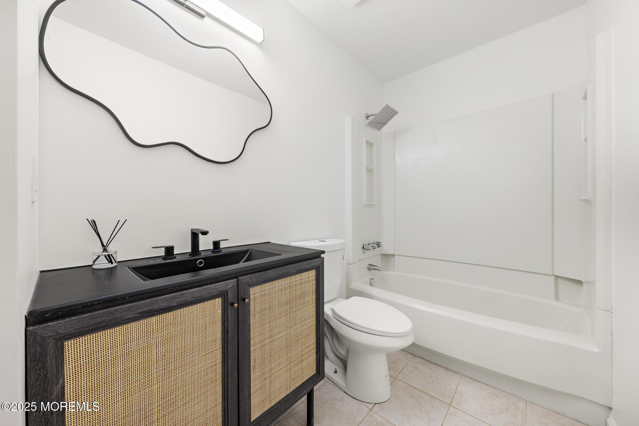 247 Jennings Road Manahawkin, NJ 08050 - Photo 15 of 16 a bathroom with a granite countertop sink a toilet and a bathtub