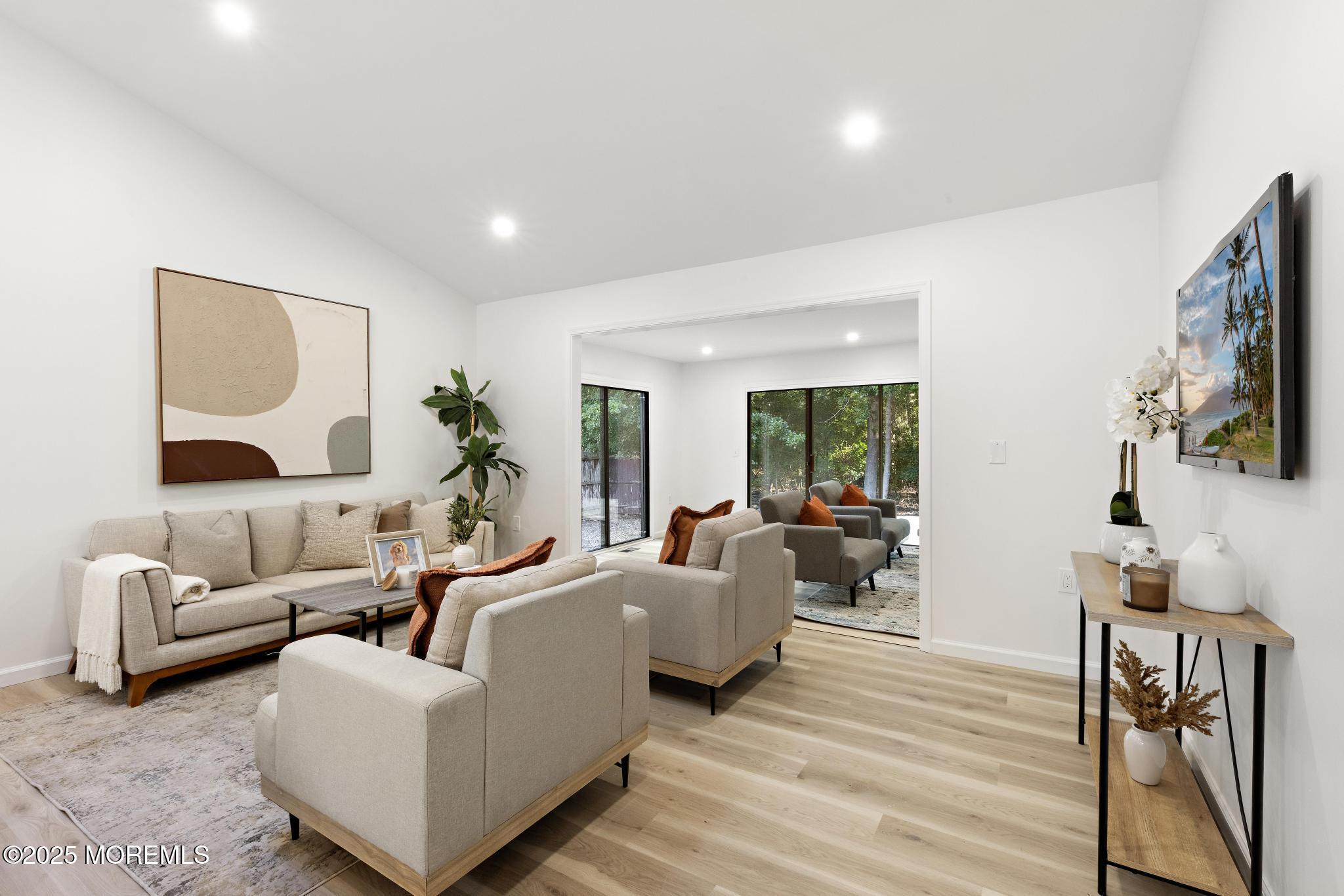 247 Jennings Road Manahawkin, NJ 08050 - Photo 17 of 35 a living room with furniture wooden floor and a flat screen tv