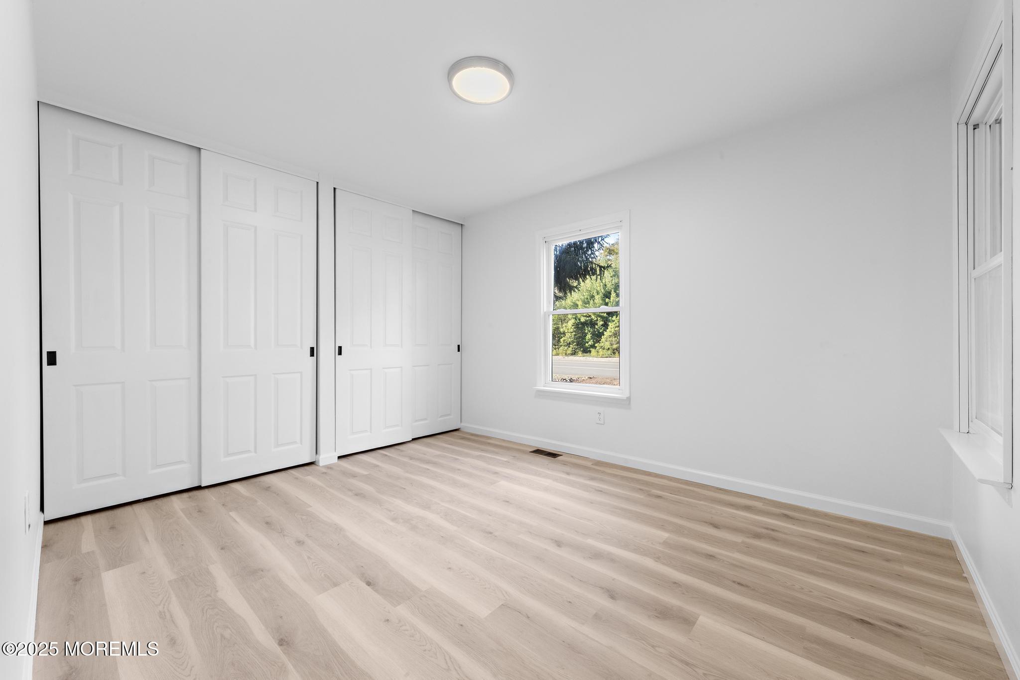247 Jennings Road Manahawkin, NJ 08050 - Photo 29 of 35 a view of an empty room with a window