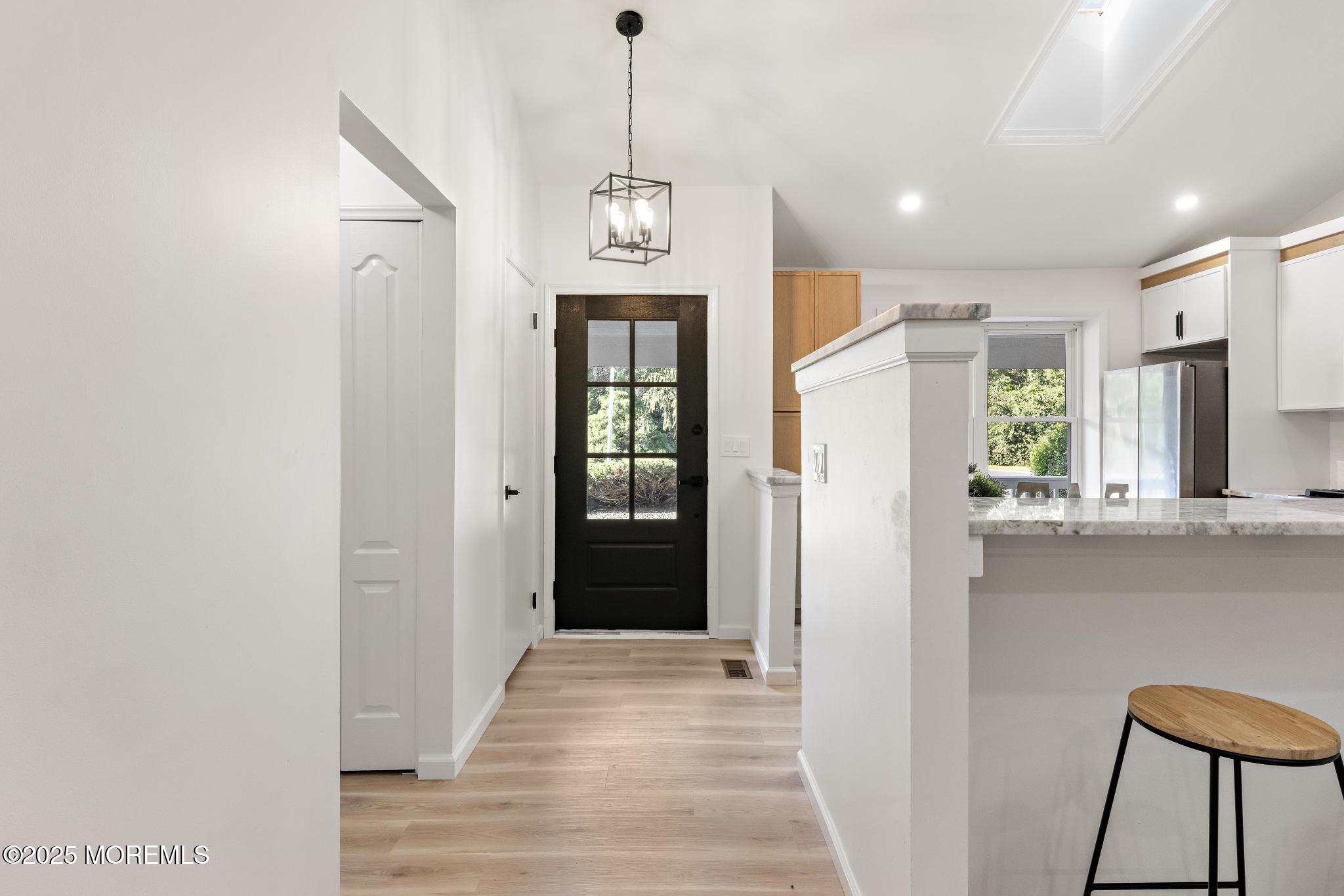 247 Jennings Road Manahawkin, NJ 08050 - Photo 3 of 35 a view of a hallway with wooden floor and a window