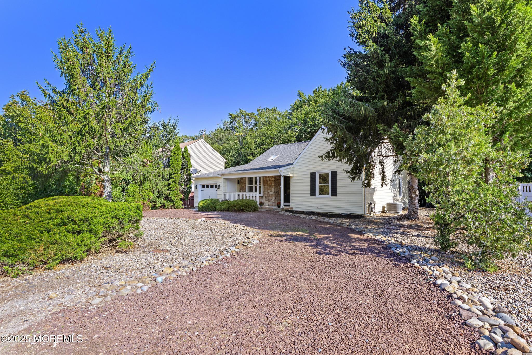 247 Jennings Road Manahawkin, NJ 08050 - Photo 34 of 35 a front view of a house with a garden