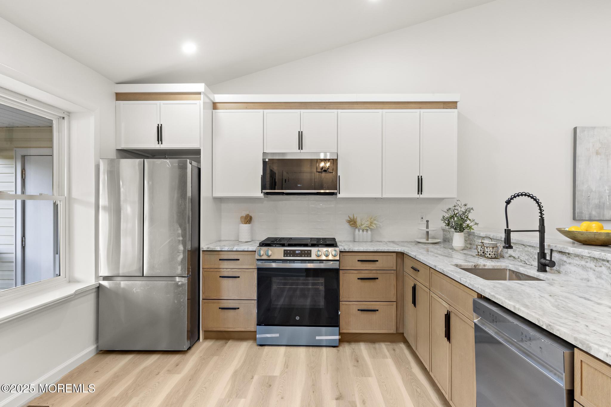 247 Jennings Road Manahawkin, NJ 08050 - Photo 4 of 16 a kitchen with a stove a sink and a refrigerator