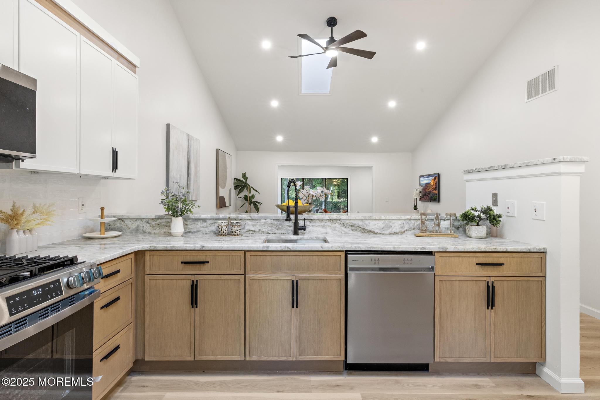247 Jennings Road Manahawkin, NJ 08050 - Photo 6 of 35 a kitchen with a sink stove and cabinets