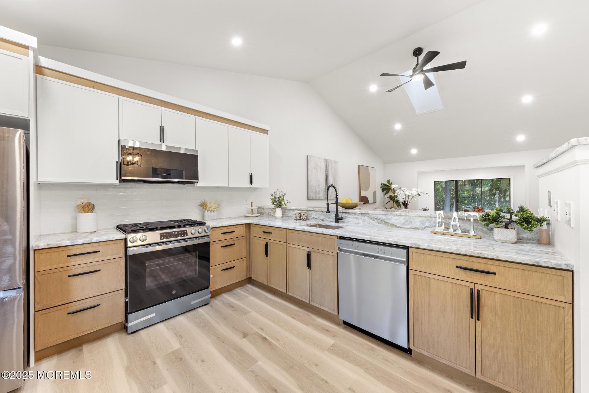247 Jennings Road Manahawkin, NJ 08050 - Photo 8 of 35 a kitchen with granite countertop cabinets stainless steel appliances and a sink