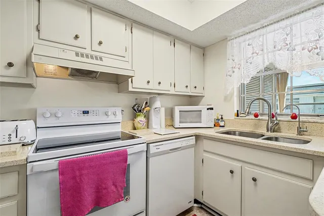 a kitchen with appliances cabinets and a sink