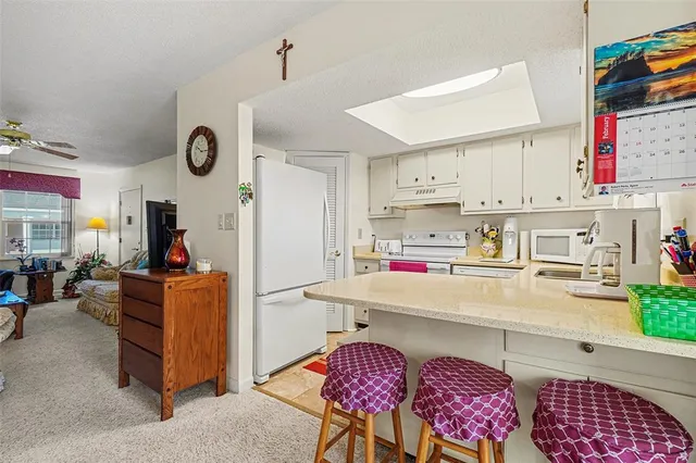 a kitchen with stainless steel appliances granite countertop a sink and cabinets