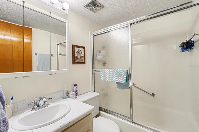 an aerial view of a house with a garden and lake view