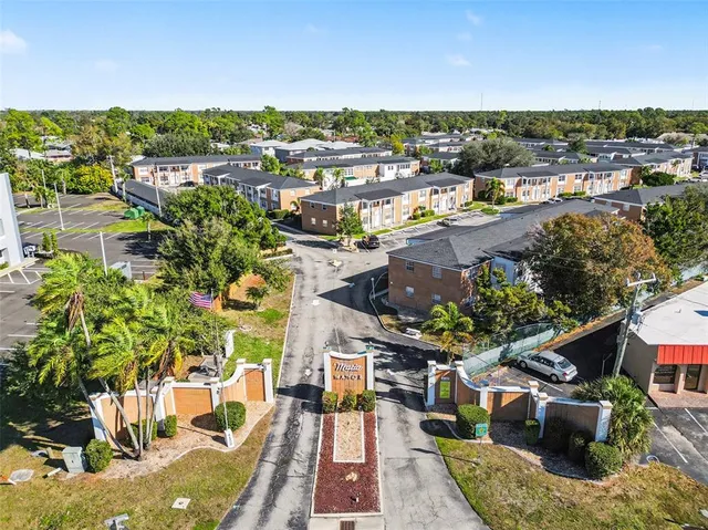 an aerial view of a house with garden space and street view