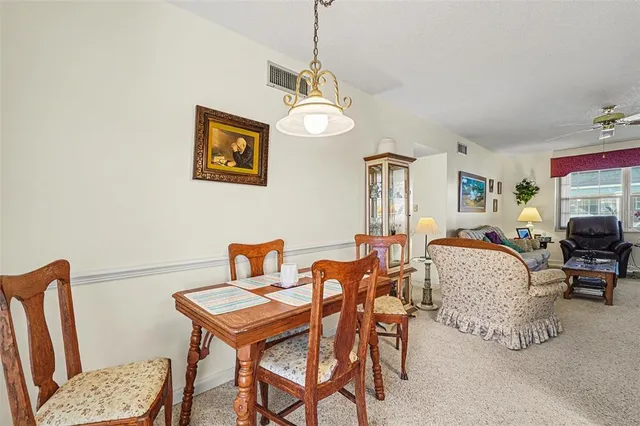 a living room with furniture a rug and a chandelier