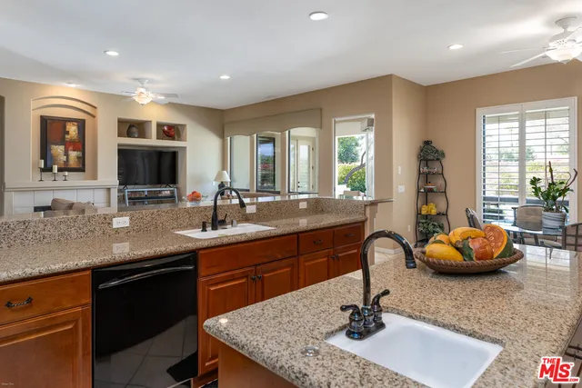 a kitchen with a sink and living room