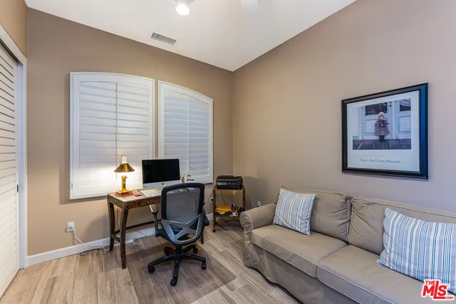 a kitchen with a refrigerator and a view of living room