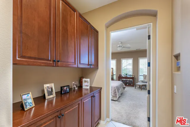 a spacious bedroom with a bed a stove and a chandelier